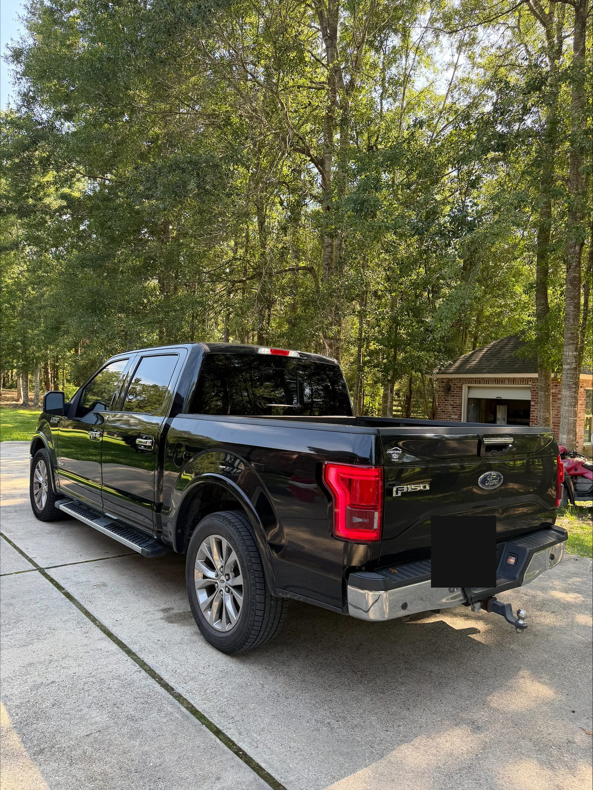Black Ford F-150 rear view with window tint
